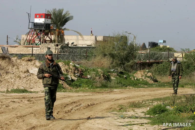 Palestinian officers stand guard during a protest demanding for Palestinian men abducted by unidentified masked gunmen, in front of the Gaza-Egypt border in Rafah in the southern Gaza Strip, on January 11, 2016. Photo by...