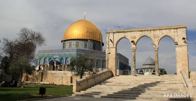 Palestinians walk near Jerusalem's Dome of the Rock mosque in the Al-Aqsa mosque compound on Jan. 11, 2016. Photo by Mahfouz Abu Turk