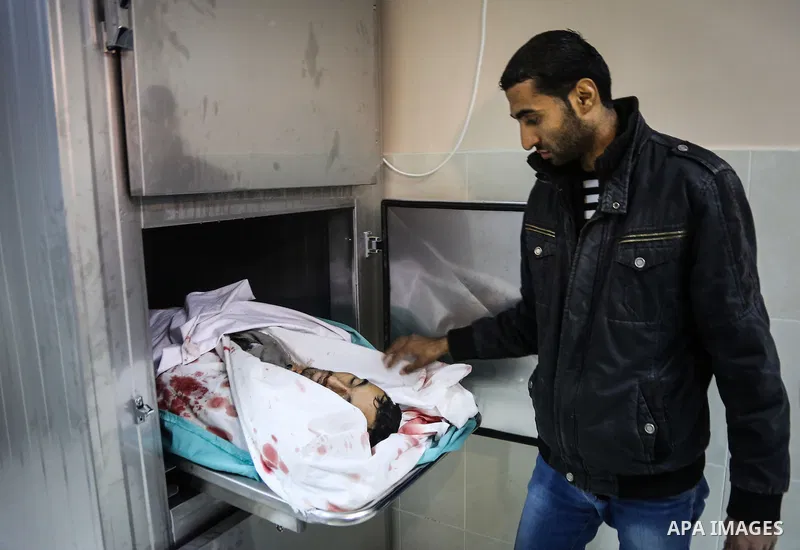 A Palestinian relative mourns over ther body of Moses Zuaiter, 31, at a hospital morgue, in Beit Lahia in the northern Gaza Strip on January 13, 2016. A Palestinian was killed and three others were injured by Israeli art...