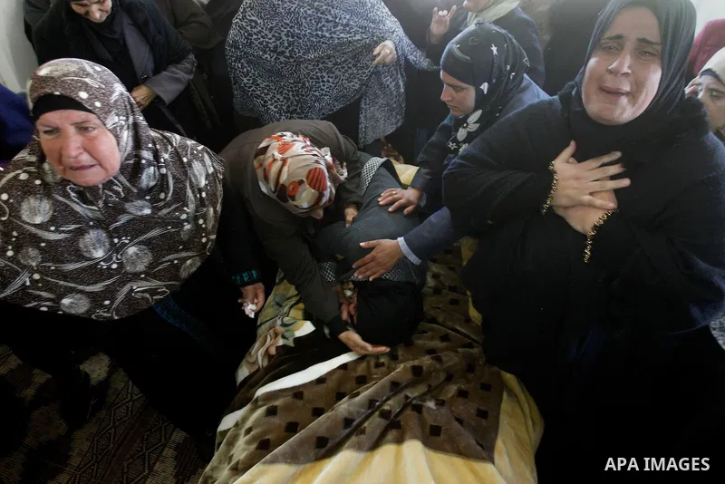 Relatives of Palestinian Mohammad Kawazbeh, who Israeli military said was shot dead by Israeli soldiers after he tried to stab a soldier on Tuesday, mourn during his funeral in the West Bank village of Sae'er near Hebron...