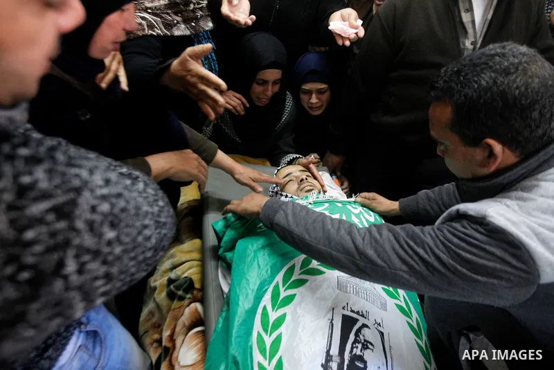 Relatives of Palestinian Mohammad Kawazbeh, who Israeli military said was shot dead by Israeli soldiers after he tried to stab a soldier on Tuesday, mourn during his funeral in the West Bank village of Sae'er near Hebron...