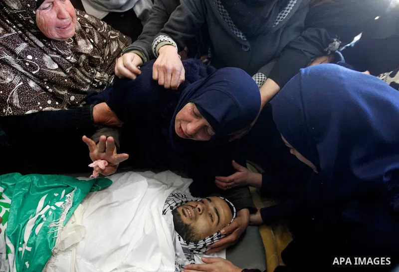 Relatives of Palestinian Mohammad Kawazbeh, who Israeli military said was shot dead by Israeli soldiers after he tried to stab a soldier on Tuesday, mourn during his funeral in the West Bank village of Sae'er near Hebron...