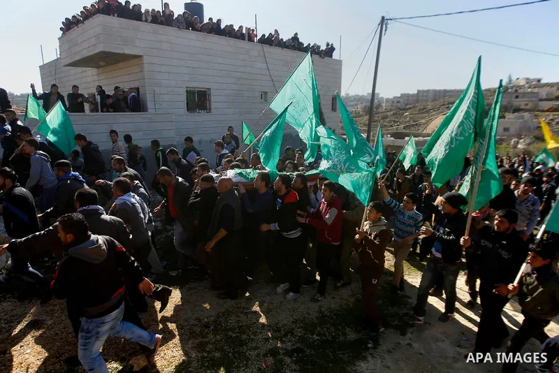 Mourners carry the body of Palestinian Mohammad Kawazbeh, who Israeli military said was shot dead by Israeli soldiers after he tried to stab a soldier on Tuesday, during his funeral in the West Bank village of Sae'er nea...