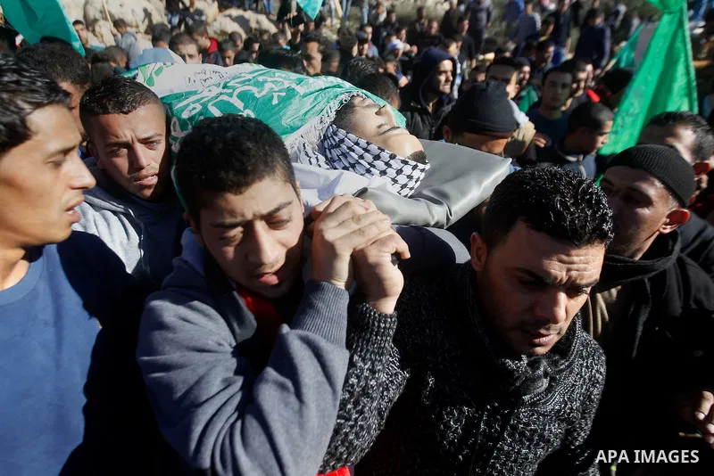 Mourners carry the body of Palestinian Mohammad Kawazbeh, who Israeli military said was shot dead by Israeli soldiers after he tried to stab a soldier on Tuesday, during his funeral in the West Bank village of Sae'er nea...