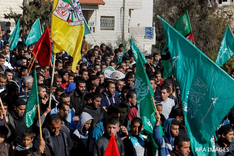 Mourners carry the body of Palestinian Mohammad Kawazbeh, who Israeli military said was shot dead by Israeli soldiers after he tried to stab a soldier on Tuesday, during his funeral in the West Bank village of Sae'er nea...