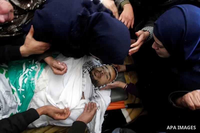Relatives of Palestinian Mohammad Kawazbeh, who Israeli military said was shot dead by Israeli soldiers after he tried to stab a soldier on Tuesday, mourn during his funeral in the West Bank village of Sae'er near Hebron...