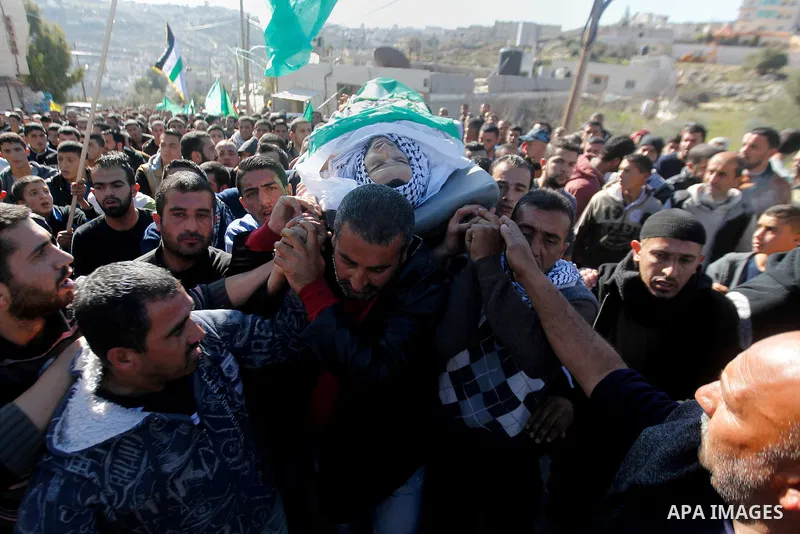 Mourners carry the body of Palestinian Mohammad Kawazbeh, who Israeli military said was shot dead by Israeli soldiers after he tried to stab a soldier on Tuesday, during his funeral in the West Bank village of Sae'er nea...