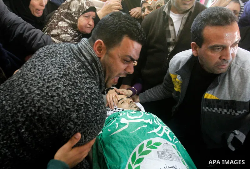 Relatives of Palestinian Mohammad Kawazbeh, who Israeli military said was shot dead by Israeli soldiers after he tried to stab a soldier on Tuesday, mourn during his funeral in the West Bank village of Sae'er near Hebron...