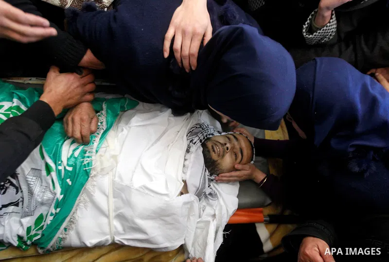 Relatives of Palestinian Mohammad Kawazbeh, who Israeli military said was shot dead by Israeli soldiers after he tried to stab a soldier on Tuesday, mourn during his funeral in the West Bank village of Sae'er near Hebron...