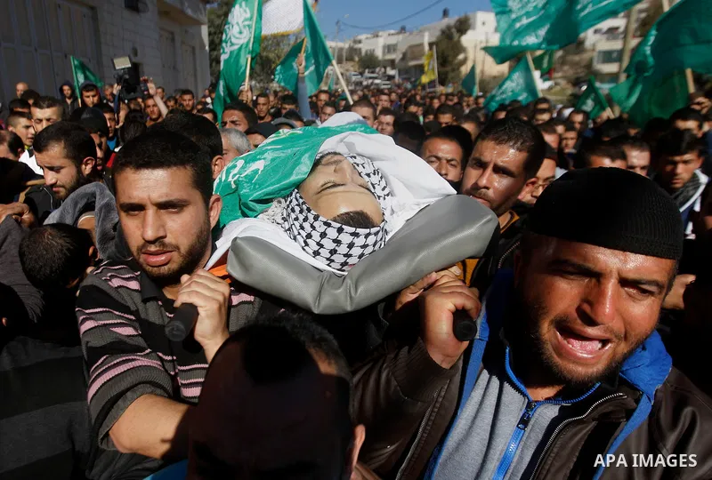 Mourners carry the body of Palestinian Mohammad Kawazbeh, who Israeli military said was shot dead by Israeli soldiers after he tried to stab a soldier on Tuesday, during his funeral in the West Bank village of Sae'er nea...
