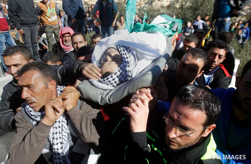 Mourners carry the body of Palestinian Mohammad Kawazbeh, who Israeli military said was shot dead by Israeli soldiers after he tried to stab a soldier on Tuesday, during his funeral in the West Bank village of Sae'er nea...