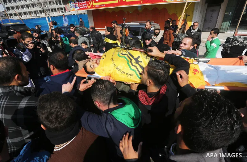 Mourners carry the body of Palestinian militant Mussa Zeater, who was killed in an attack by an Israeli aircraft, during his funeral in the northern Gaza Strip January 13, 2016. The Israeli aircraft attacked a group of P...