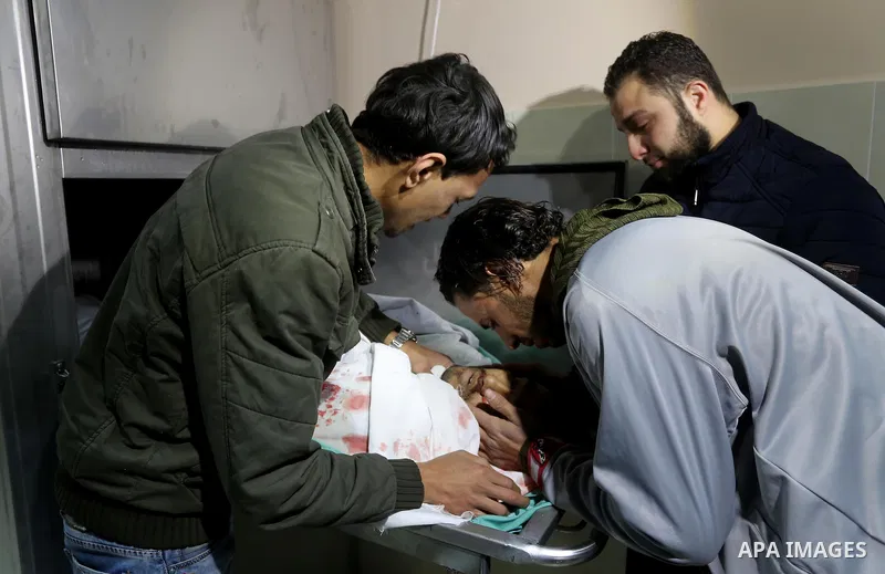 Relatives of Palestinian Moussa Zuaiter, mourn over his body at a morgue in hospital in the northern Gaza Strip January 13, 2016. The Israeli aircraft attacked a group of Palestinians in the Gaza Strip on Wednesday who t...