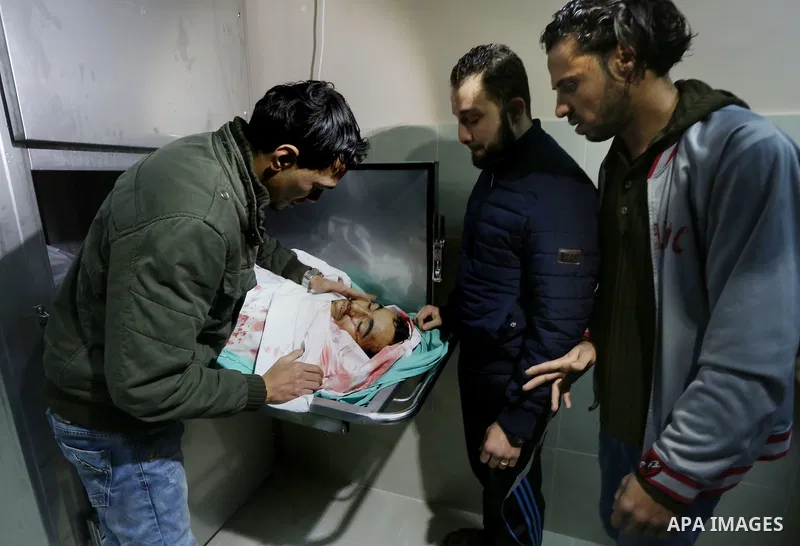 Relatives of Palestinian Moussa Zuaiter, mourn over his body at a morgue in hospital in the northern Gaza Strip January 13, 2016. The Israeli aircraft attacked a group of Palestinians in the Gaza Strip on Wednesday who t...