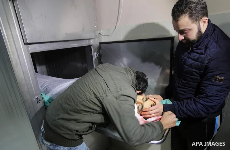 Relatives of Palestinian Moussa Zuaiter, mourn over his body at a morgue in hospital in the northern Gaza Strip January 13, 2016. The Israeli aircraft attacked a group of Palestinians in the Gaza Strip on Wednesday who t...