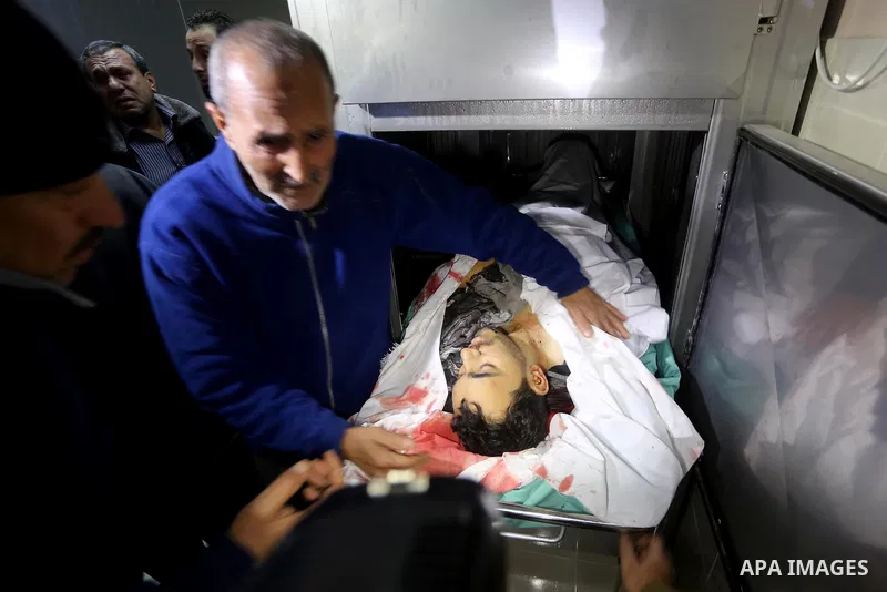 Relatives of Palestinian Moussa Zuaiter, mourn over his body at a morgue in hospital in the northern Gaza Strip January 13, 2016. The Israeli aircraft attacked a group of Palestinians in the Gaza Strip on Wednesday who t...