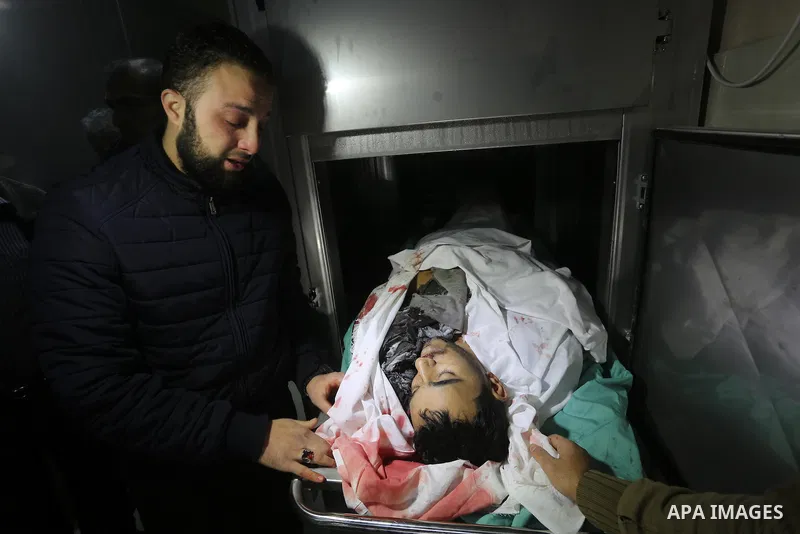 Relatives of Palestinian Moussa Zuaiter, mourn over his body at a morgue in hospital in the northern Gaza Strip January 13, 2016. The Israeli aircraft attacked a group of Palestinians in the Gaza Strip on Wednesday who t...