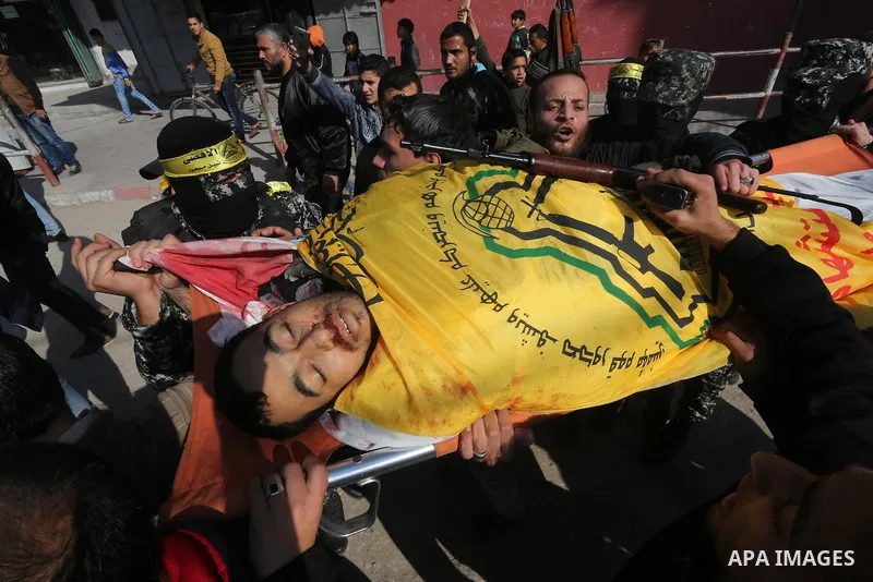 Mourners carry the body of Palestinian militant Mussa Zeater, who was killed in an attack by an Israeli aircraft, during his funeral in the northern Gaza Strip January 13, 2016. The Israeli aircraft attacked a group of P...