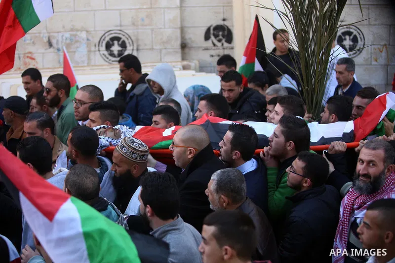 Mourners carry the body of Palestinian Mustafa al-Khatib,17, who Israeli military said was shot dead by Israeli soldiers after he tried to stab a soldier on 12 October, during his funeral in the West Bank city of Ramalla...