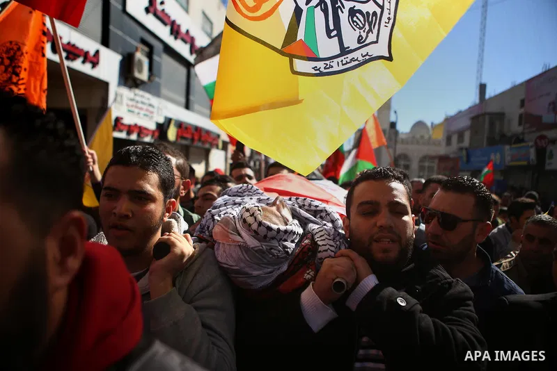Mourners carry the body of Palestinian Mustafa al-Khatib,17, who Israeli military said was shot dead by Israeli soldiers after he tried to stab a soldier on 12 October, during his funeral in the West Bank city of Ramalla...