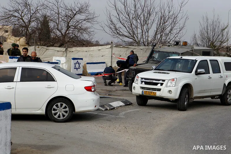 Israeli forensic policemen gather evidence at the site of a stabbing attack at the Beit Ainun junction near Hebron on January 14, 2016. Israeli forces Thursday shot and killed a Palestinian near the Beit Ainun junction n...