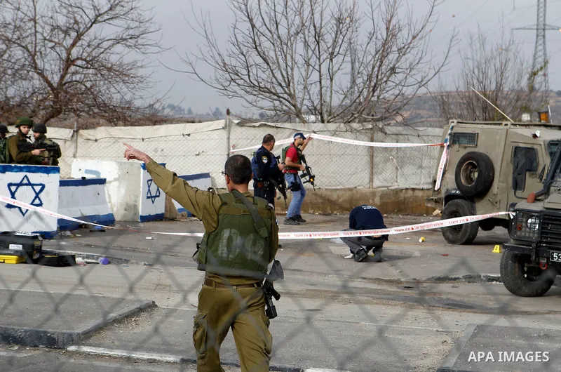 Israeli forensic policemen gather evidence at the site of a stabbing attack at the Beit Ainun junction near Hebron on January 14, 2016. Israeli forces Thursday shot and killed a Palestinian near the Beit Ainun junction n...
