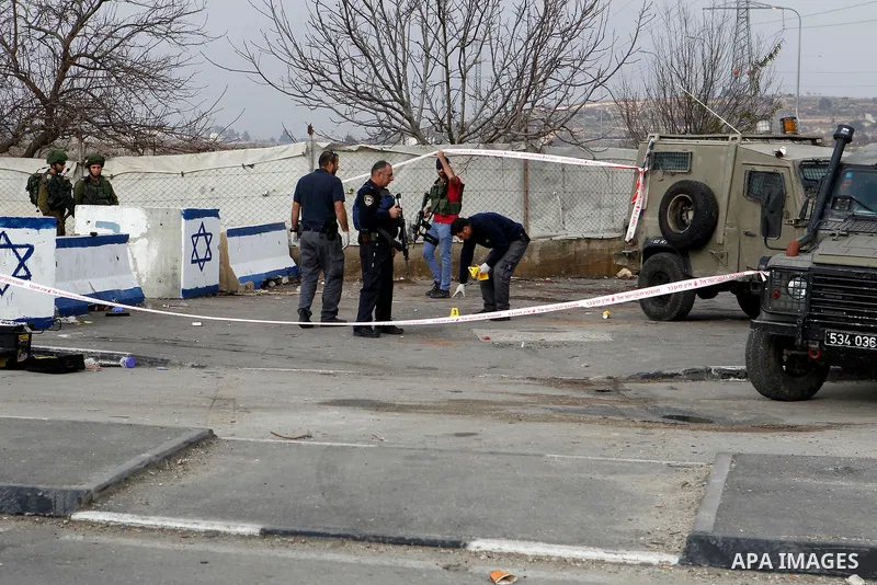 Israeli forensic policemen gather evidence at the site of a stabbing attack at the Beit Ainun junction near Hebron on January 14, 2016. Israeli forces Thursday shot and killed a Palestinian near the Beit Ainun junction n...