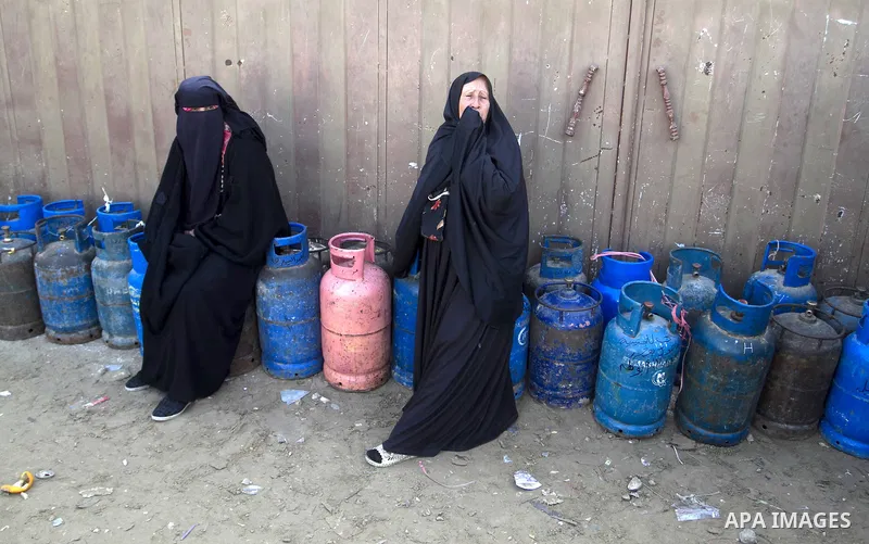 Palestinians wait to fill a cooking gas canister at a station in Rafah in southern Gaza Strip on January 14, 2016. Gas used for heating and cooking in Gaza is in short supply because of rationing. The power shortage stem...