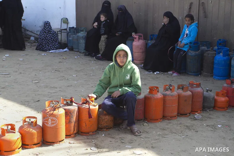 Palestinians wait to fill a cooking gas canister at a station in Rafah in southern Gaza Strip on January 14, 2016. Gas used for heating and cooking in Gaza is in short supply because of rationing. The power shortage stem...