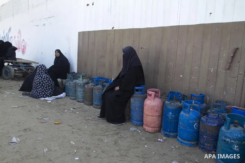 Palestinians wait to fill a cooking gas canister at a station in Rafah in southern Gaza Strip on January 14, 2016. Gas used for heating and cooking in Gaza is in short supply because of rationing. The power shortage stem...