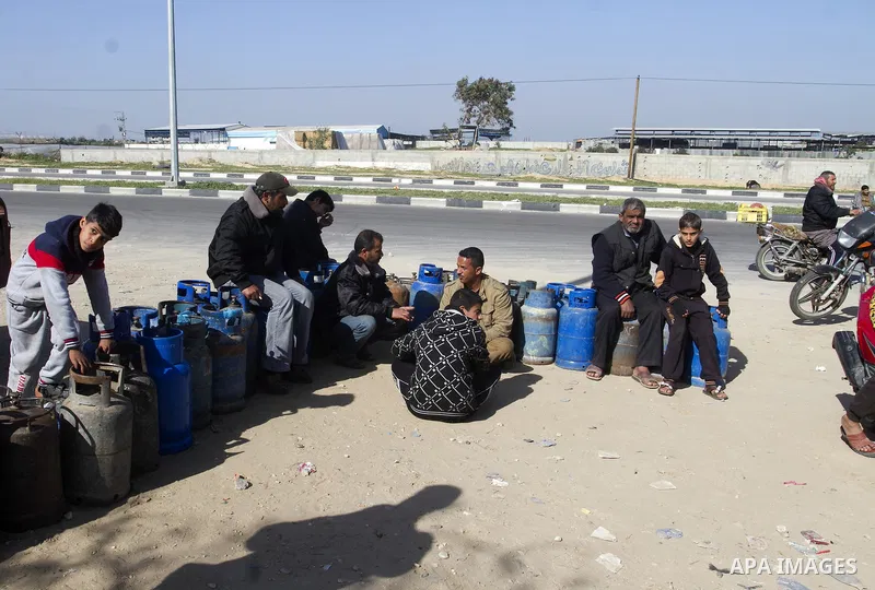 Palestinians wait to fill a cooking gas canister at a station in Rafah in southern Gaza Strip on January 14, 2016. Gas used for heating and cooking in Gaza is in short supply because of rationing. The power shortage stem...