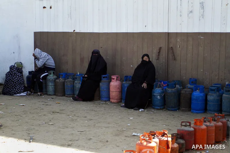 Palestinians wait to fill a cooking gas canister at a station in Rafah in southern Gaza Strip on January 14, 2016. Gas used for heating and cooking in Gaza is in short supply because of rationing. The power shortage stem...