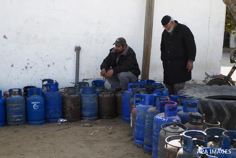 Palestinians wait to fill a cooking gas canister at a station in Rafah in southern Gaza Strip on January 14, 2016. Gas used for heating and cooking in Gaza is in short supply because of rationing. The power shortage stem...