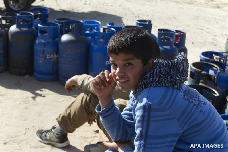 Palestinians wait to fill a cooking gas canister at a station in Rafah in southern Gaza Strip on January 14, 2016. Gas used for heating and cooking in Gaza is in short supply because of rationing. The power shortage stem...
