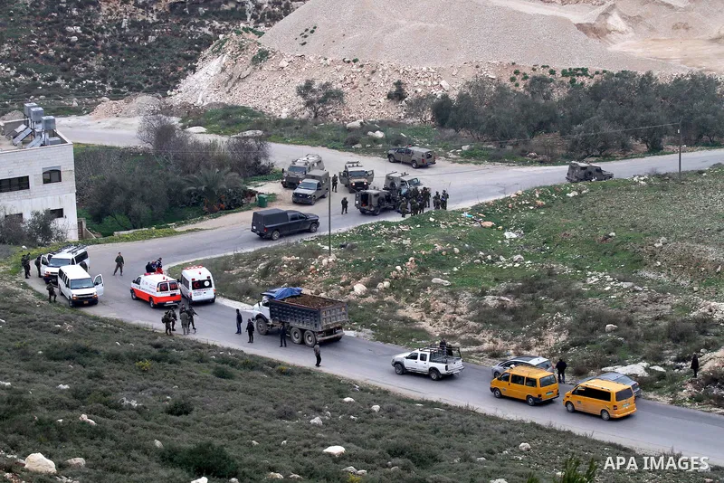 Israeli security forces monitor the site where a Palestinian man was shot dead following a reported stabbing attack in the village of Assira al-Shamaliya near the city of Nablus, in the occupied West Bank, on January 14,...