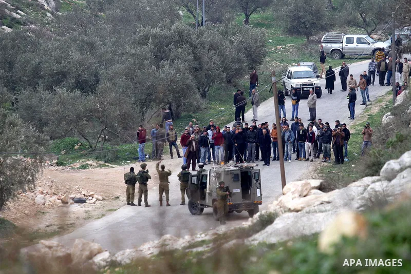 Israeli security forces monitor the site where a Palestinian man was shot dead following a reported stabbing attack in the village of Assira al-Shamaliya near the city of Nablus, in the occupied West Bank, on January 14,...