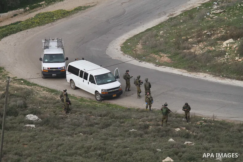 Israeli security forces monitor the site where a Palestinian man was shot dead following a reported stabbing attack in the village of Assira al-Shamaliya near the city of Nablus, in the occupied West Bank, on January 14,...