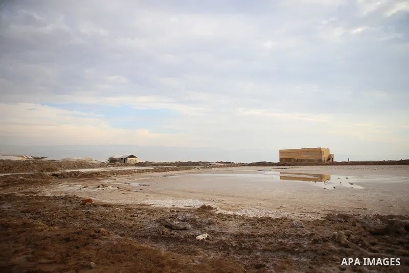 A general veiw show the salt extraction "raw material" from the Dead Sea, in the West Bank city of Jericho on January 14, 2016. The Dead Sea also called the Salt Sea, is a salt lake with borders to Jordan in the east and...