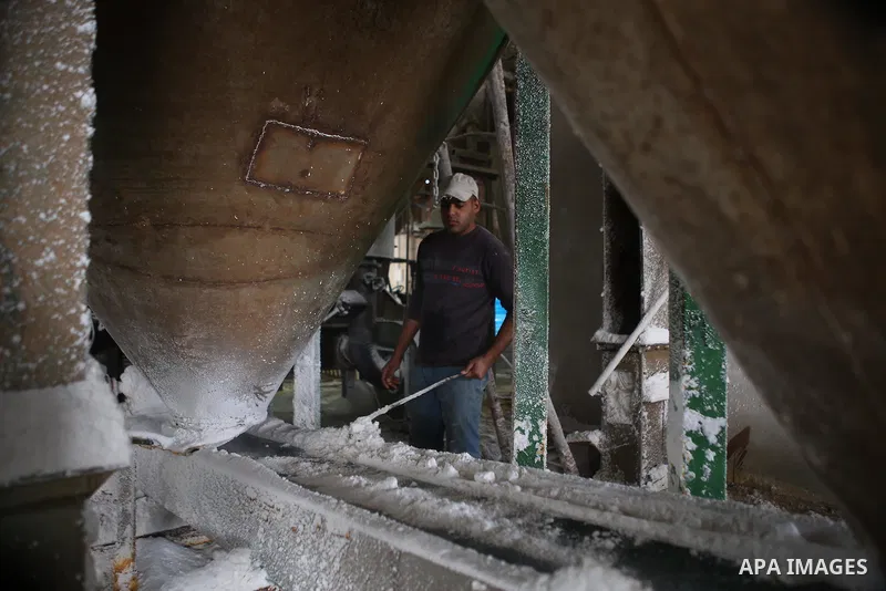 A Palestinian worker extracts salt from the Dead Sea, at his factory, in the West Bank city of Jericho on January 14, 2016. The Dead Sea also called the Salt Sea, is a salt lake with borders to Jordan in the east and the...