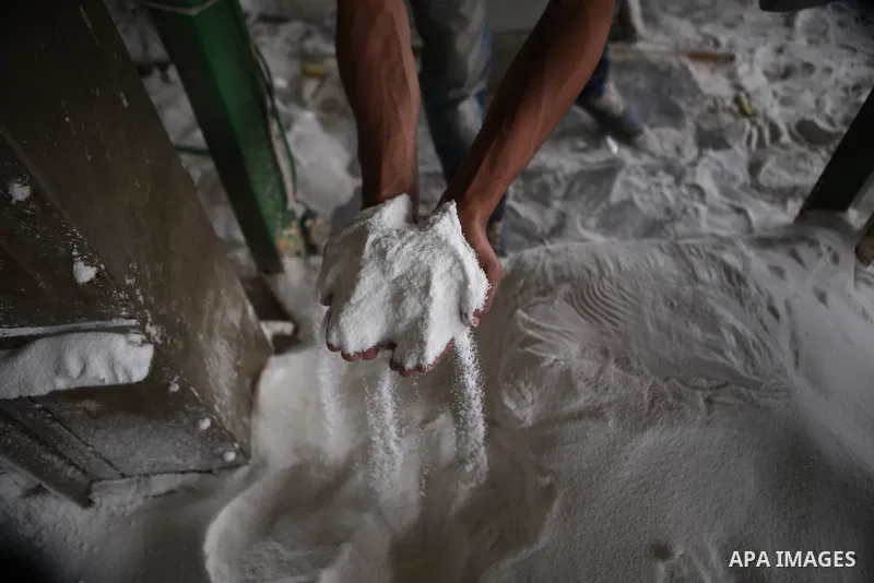 A Palestinian worker extracts salt from the Dead Sea, at his factory, in the West Bank city of Jericho on January 14, 2016. The Dead Sea also called the Salt Sea, is a salt lake with borders to Jordan in the east and the...