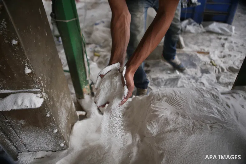 A Palestinian worker extracts salt from the Dead Sea, at his factory, in the West Bank city of Jericho on January 14, 2016. The Dead Sea also called the Salt Sea, is a salt lake with borders to Jordan in the east and the...