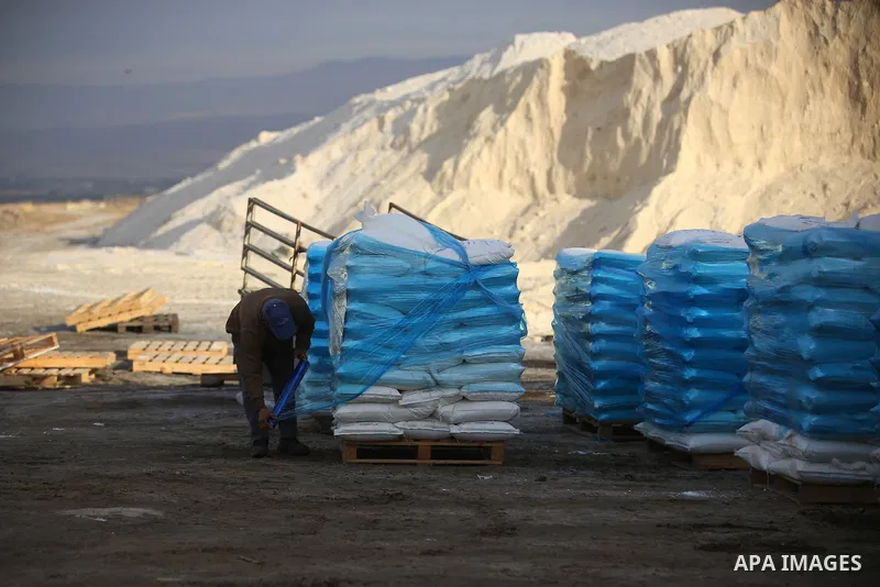 A Palestinian worker extracts salt from the Dead Sea, outside his factory in the West Bank city of Jericho on January 14, 2016. The Dead Sea also called the Salt Sea, is a salt lake with borders to Jordan in the east and...