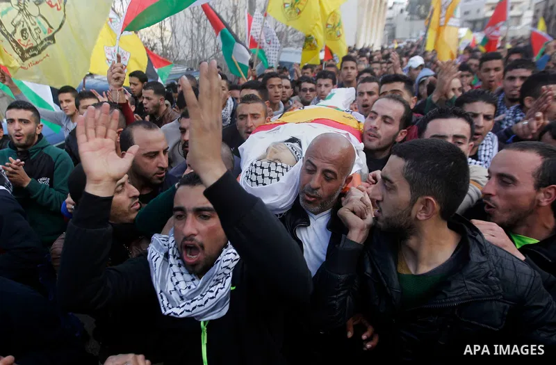 Mourners carry the body of Palestinian Moayad al-Jabreen during his funeral in the West Bank village of Sair, east of Hebron, on January 15, 2016. The 20-year-old man was shot dead the previous day by Israeli security fo...