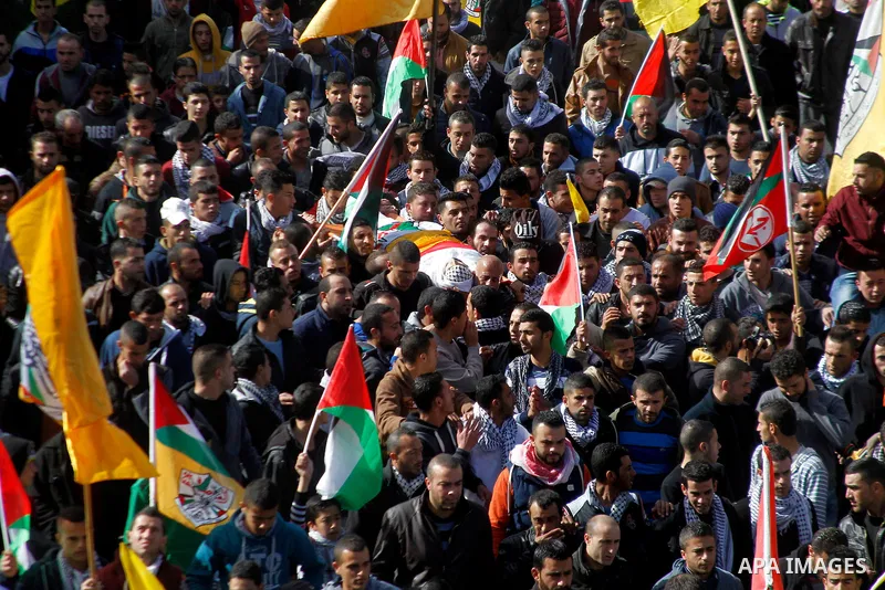 Mourners carry the body of Palestinian Moayad al-Jabreen during his funeral in the West Bank village of Sair, east of Hebron, on January 15, 2016. The 20-year-old man was shot dead the previous day by Israeli security fo...