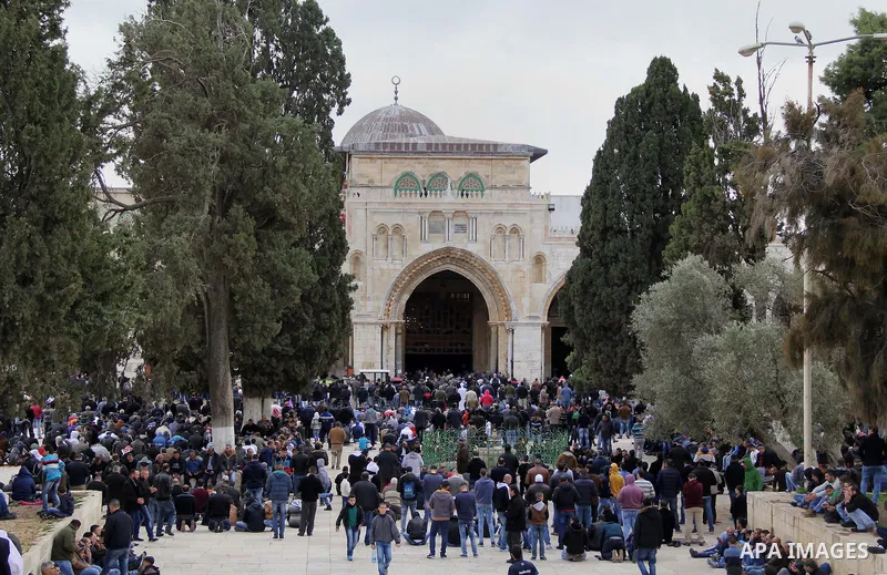 Palestinian Muslim worshipers attend Friday prayers outside al-Aqsa mosque, Islam's third holiest site, in Jerusalem's Old city on Jan. 15, 2016. Photo by Mahfouz Abu Turk