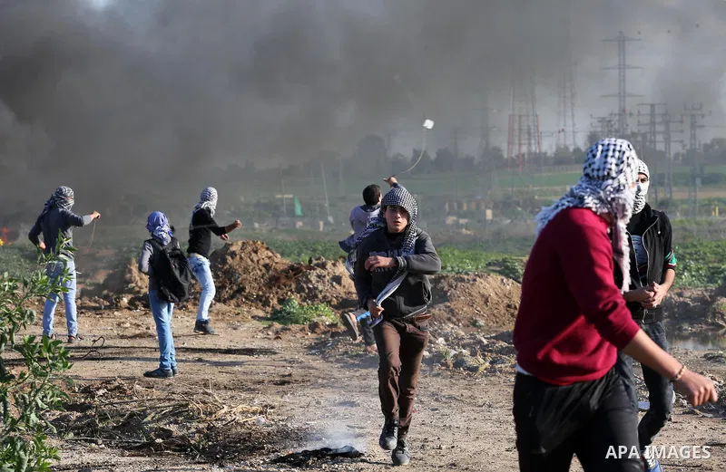 Palestinian protesters clash with Israeli security forces along the border fence with Israel on the eastern outskirts of Gaza City on Jan. 15, 2016. Israeli forces on Friday afternoon shot dead a Palestinian teenager dur...