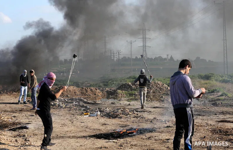 Palestinian protesters clash with Israeli security forces along the border fence with Israel on the eastern outskirts of Gaza City on Jan. 15, 2016. Israeli forces on Friday afternoon shot dead a Palestinian teenager dur...