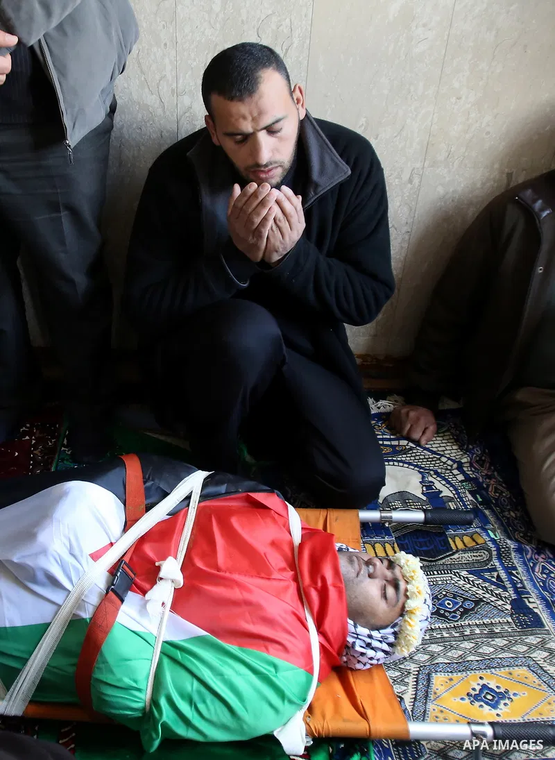 Palestinians pray at a mosque near the body of Haytham Yassin during his funeral in the village of Assira al-Shamaliya near Nablus, in the Israeli-occupied West Bank, on January 15, 2016. The Palestinian man stabbed an I...