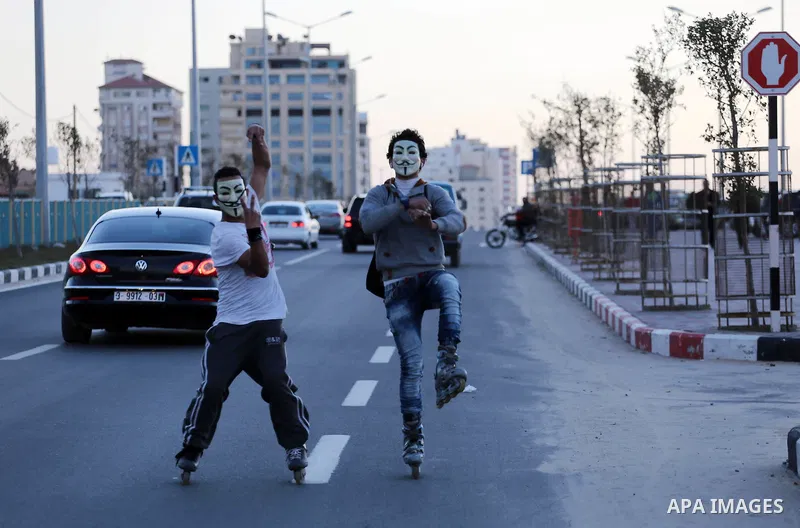 Palestinian youths show thier skills of using roller-skating on the beach of the Mediterranean Sea in Gaza City, on Jan. 15, 2016. Photo by Mohammed Asad