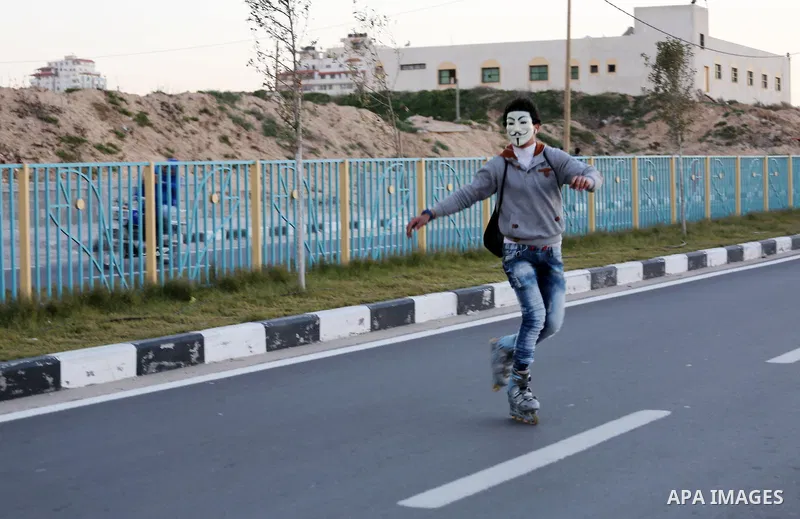 A Palestinian youth shows his skills of using roller-skating on the beach of the Mediterranean Sea in Gaza City, on Jan. 15, 2016. Photo by Mohammed Asad